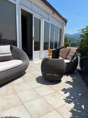 a patio with two wicker chairs and a couch at Holiday Home Barska Vila in Bar