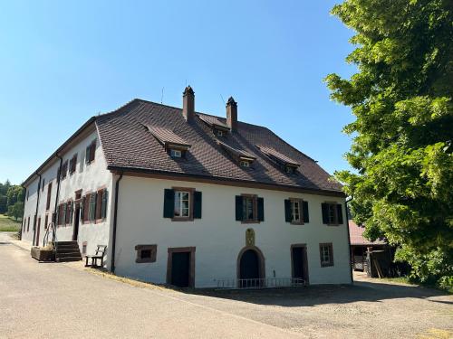 a large white building with a brown roof at Metzlinschwander Hof in Marxzell