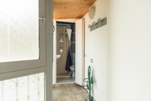 a door leading into a bathroom with a toilet at Casa liberty style in Milan