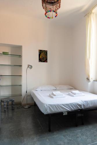 a bedroom with a bed and a chandelier at Casa liberty style in Milan