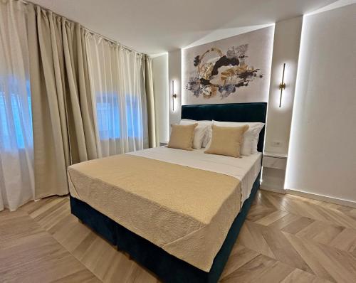 a bedroom with a large bed in a room at Villa Olivetta heritage residence in Crikvenica