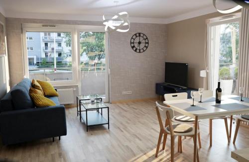 a living room with a couch and a table at Apartament Amerigo in Wrocław