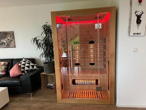 a glass door in a living room next to a couch at Ferienhaus Wendelinus mit Pool & Sauna in Hausach