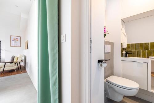 a bathroom with a toilet and a sink at GuestReady - A minimalist comfort in Vanves in Vanves