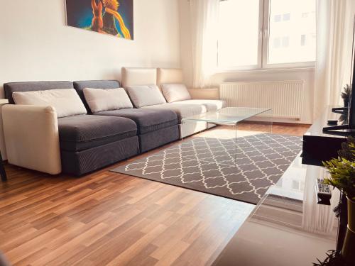 a living room with a couch and a table at After Eight Apartment in Bratislava