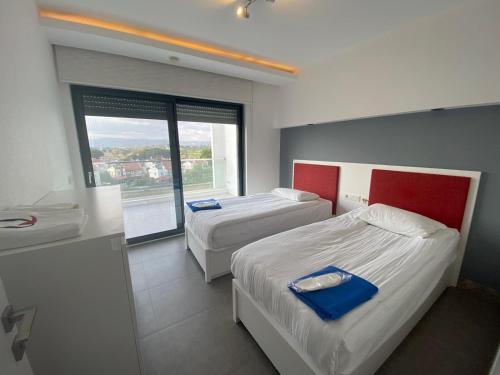 a hotel room with two beds and a window at Q SPA RESİDANCE in Side