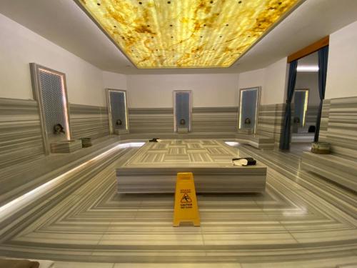 a gymnasium with a yellow caution cone in the middle of a room at Q SPA RESİDANCE in Side