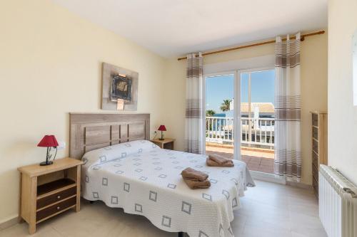 a bedroom with two beds and a balcony at La Cala in Cabo de Palos