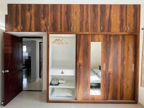 a large wooden cabinet in a room with a bed at SSN Home Stays in Bangalore near PLAY Arena in Bangalore