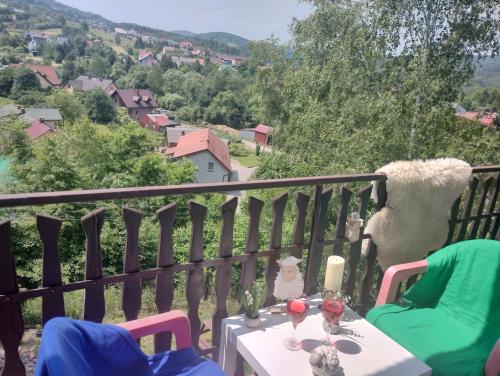 a balcony with a table and chairs with a view at Nowa Jutrzenka in Stryszawa