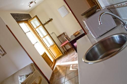 a bathroom with a stainless steel sink in a room at Apartamentos El Picoretu in Mestas de Con