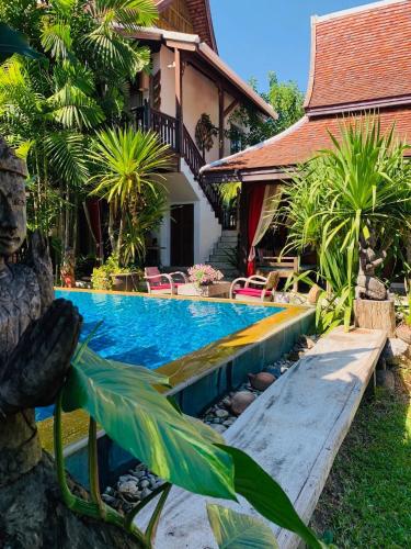 a swimming pool in front of a house at Hongkhao Village in Chiang Mai