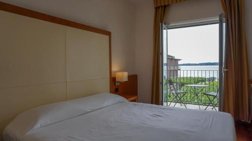 Postel nebo postele na pokoji v ubytování Hotel Mavino