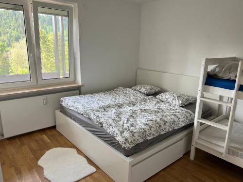 a bedroom with a bunk bed and a ladder at Bergblick Buchenhöhe in Berchtesgaden