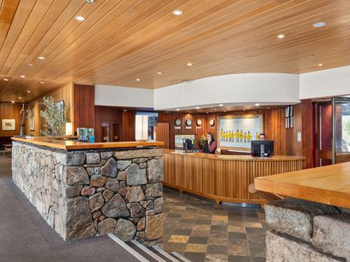 a lobby of a hotel with a stone bar at Thredbo Alpine Hotel in Thredbo