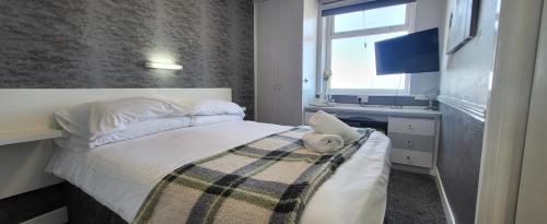 a bedroom with a bed and a sink and a window at The Blenheim Mount Hotel in Blackpool
