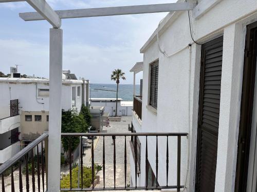a balcony with a view of the ocean at Seaside Apartments in Paphos City