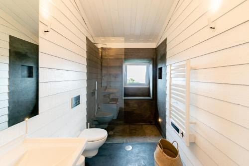 a bathroom with a toilet and a sink at Casas da Prainha B in Santo Amaro