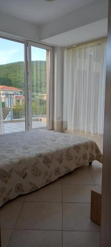 1 dormitorio con cama y ventana grande en Апартамент в Комплексе Сансет Кошарица,Солнечный берег, en Kosharitsa