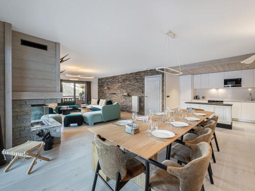 - une salle à manger et un salon avec une grande table et des chaises dans l'établissement Appartement Moderne avec Cheminée, Balcon Sud et Proche Télésiège à Méribel - FR-1-565-62, à Les Allues