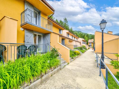 a street view of a building with a street light at Vacancéole - Résidence Les Gorges Rouges in Guillaumes