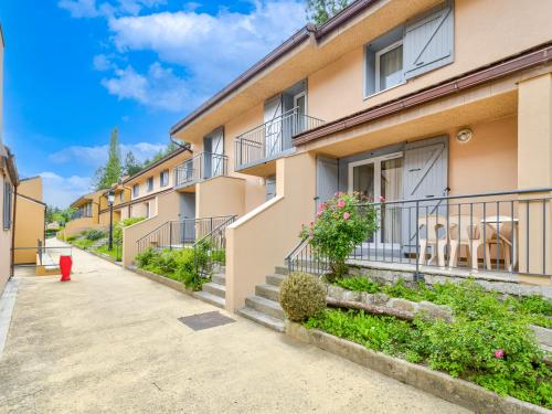 a row of apartment buildings with balconies at Vacancéole - Résidence Les Gorges Rouges in Guillaumes