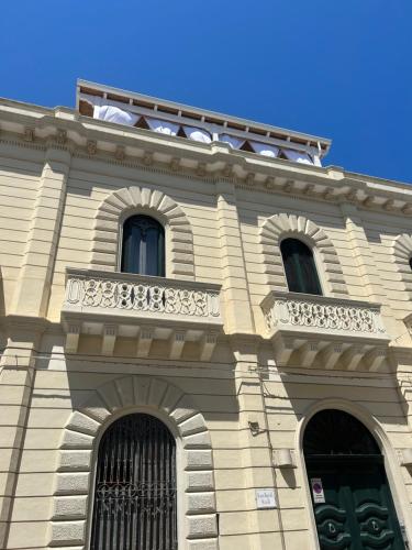 a building with a balcony on top of it at Palazzo Angelelli in Gallipoli