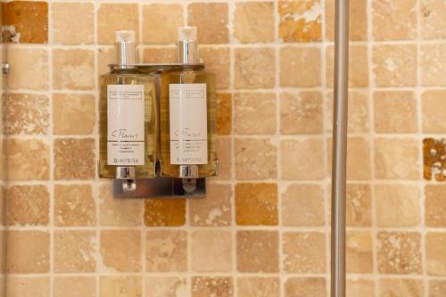 a soap dispenser on the wall of a bathroom at Trewhiddle Retreat V25 by Together Travel - Luxury 4-Bedroom Villa in St Austell