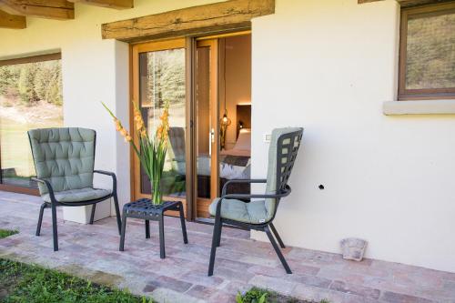 two chairs and a table on a patio at Aura Relais in Urbino