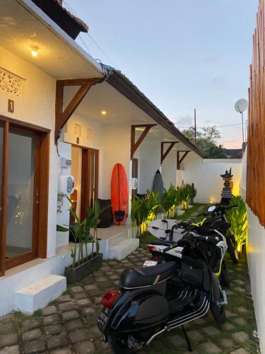 a row of motorcycles parked outside of a building at Five Rooms in Canggu