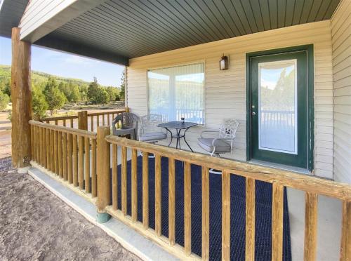 a porch of a house with a table and chairs at Robins Roost A in Hatch