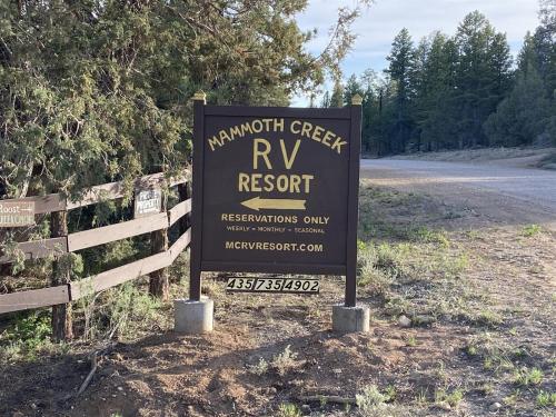 a sign for a rv resort next to a road at Robins Roost A in Hatch