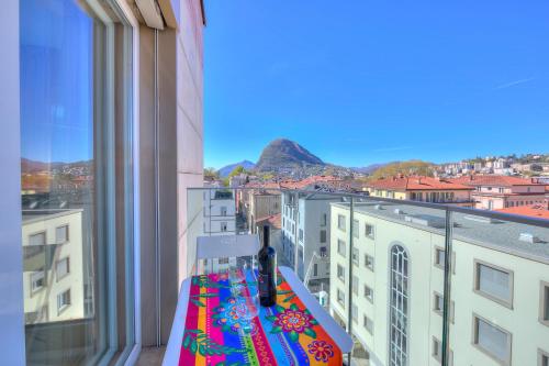 a balcony with a view of a city at Attico Al Parco - Happy Rentals in Lugano