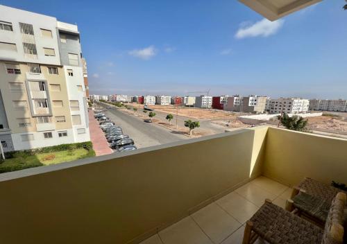 a balcony with a view of a street and buildings at Splendide Appartement avec Piscine à Agadir in Agadir