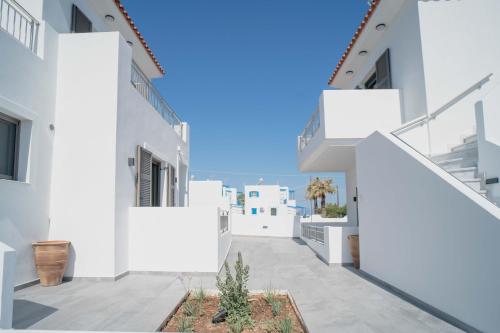 a view of a white building with white walls at Agistri Beach in Skala