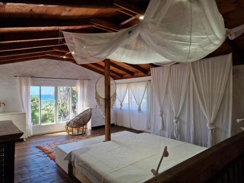 a bedroom with a large bed with a canopy at Bolonia Beach Campus in Tarifa