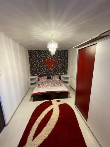 a bedroom with a bed with a red heart wall at Zya Home Central in Oradea