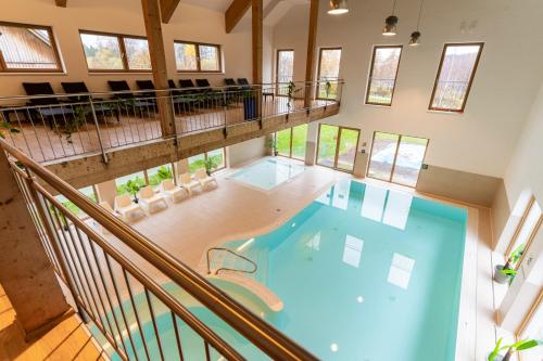 an overhead view of a large swimming pool in a house at Dormio Resort Obertraun in Obertraun