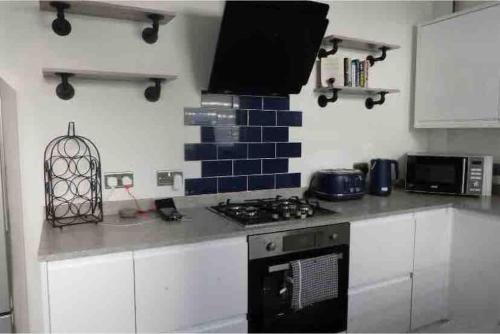 a kitchen with a counter top with a stove top oven at Balmoral Place, Ramsgate - 5 mins walk to Beach in Kent