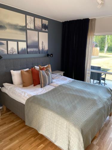a bedroom with a large bed and a large window at Bedinge Golfklubb hotell in Beddinge Strand