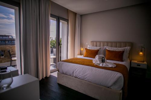a bedroom with a large bed and a large window at 262 Boutique Aliados in Porto