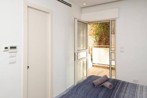 a bedroom with a bed with two pillows on it at Spacious & Modern 5 bed in the Center of Rechavia! in Jerusalem