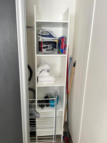 un armario con estanterías blancas y un estante con artículos en Superbe appartement plein centre de Lyon, en Lyon