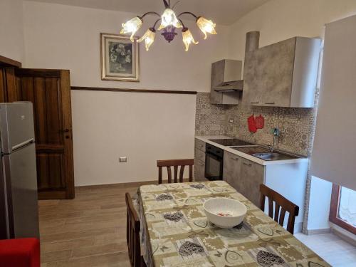 a kitchen with a table with a bowl on it at Appartamento Filomena scano di montiferro in Scano Montiferro