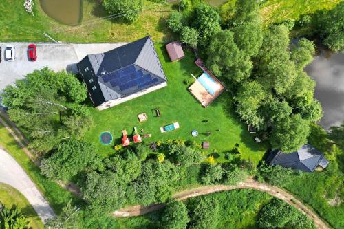 an overhead view of a large house with a solarium at Apartmány Nad rybníky in Horní Planá
