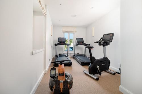 a gym with several exercise bikes in a room at Riva Marina Hvar Hotel in Hvar