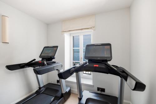two exercise bikes in a room with a window at Riva Marina Hvar Hotel in Hvar