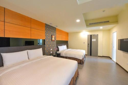 Postel nebo postele na pokoji v ubytování San Juan Easy Stay Inn Tainan