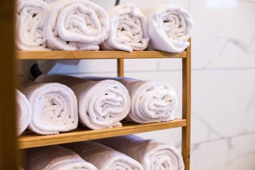 a pile of rolled towels on a wooden shelf at Holiday home Anica in Čavoglave