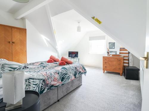 a bedroom with a bed and a staircase at Lodestar in Deganwy